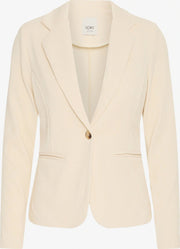 Front view of the ICHI KATE ivory corduroy blazer with notched lapels, one brown button and two welt pockets.