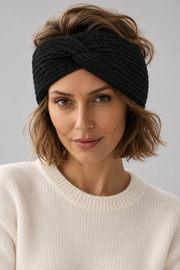 Woman wearing a black s.Oliver twist headband with a cream jumper against a neutral background