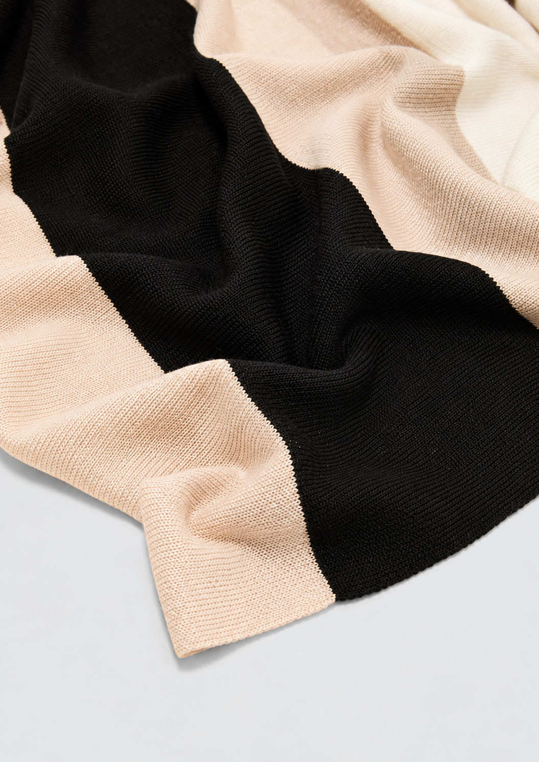 Close-up of the fine knit and beige, cream and black stripes on the s.Oliver loop scarf