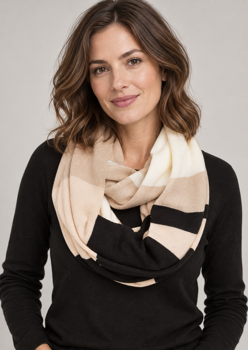 Model wearing the beige, cream and black s.Oliver loop scarf against a neutral studio background