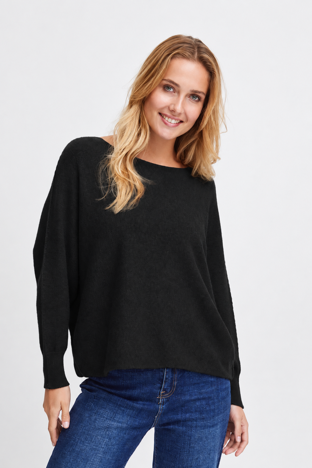 Front view of the Sorbet Basil black long-sleeve knit jumper worn with blue jeans