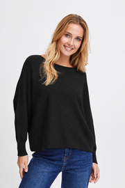 Front view of the Sorbet Basil black long-sleeve knit jumper worn with blue jeans